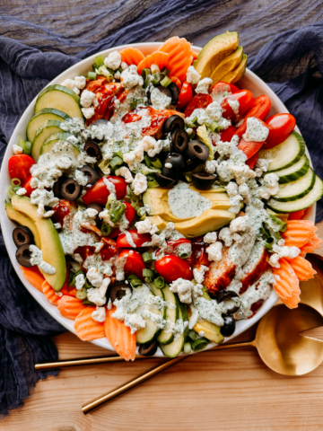 a bbq chicken salad topped with buttermilk jalapeno ranch dressing