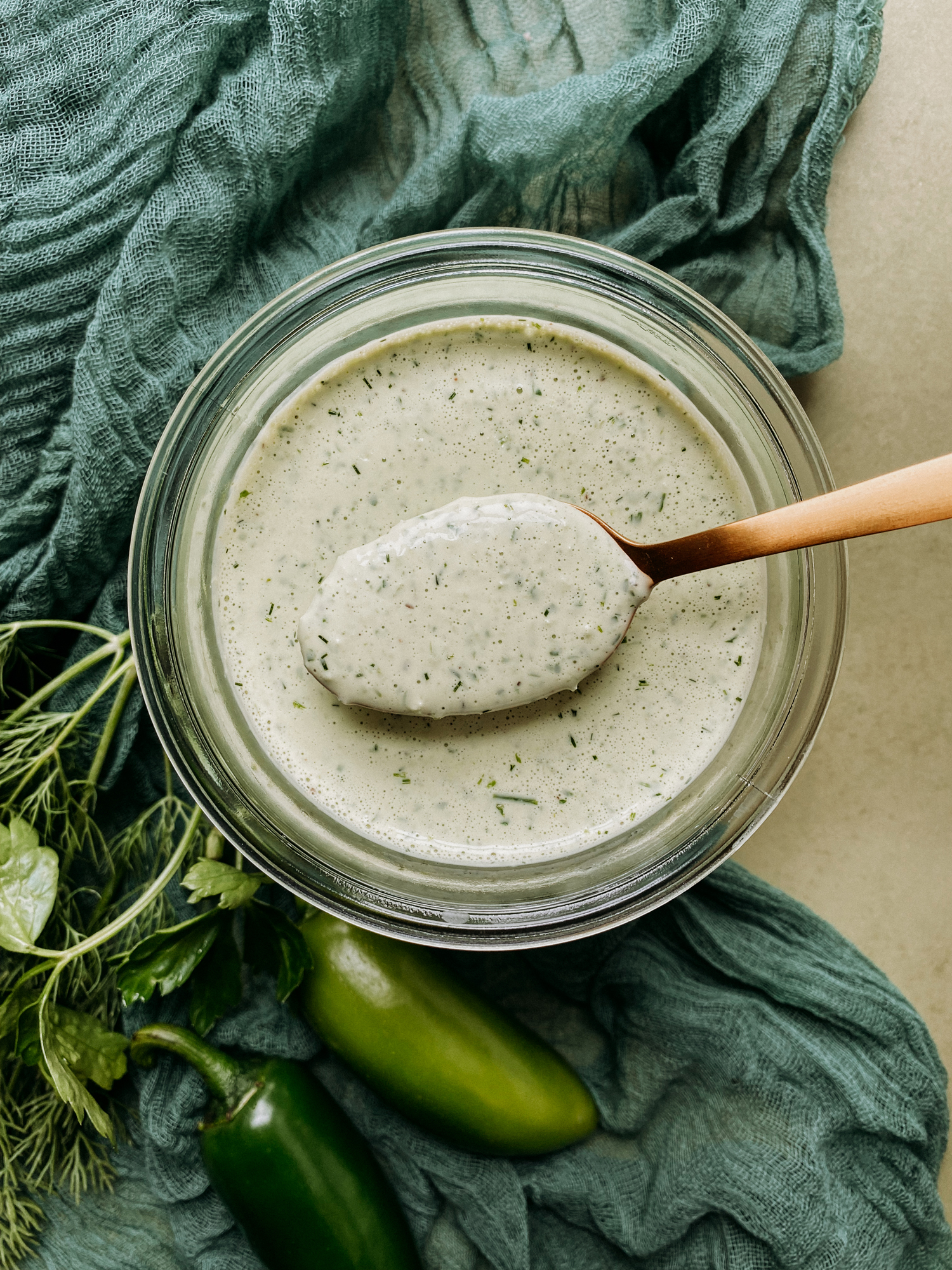 Buttermilk Jalapeno Ranch Dressing being spooned out by a gold spoon