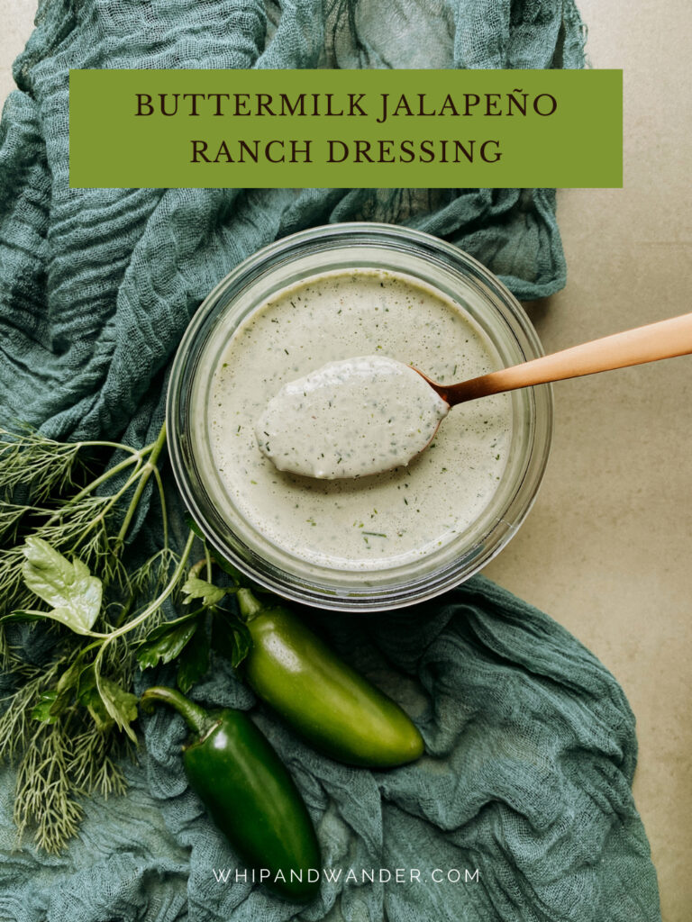 a green cloth with a jar of Buttermilk Jalapeno Ranch Dressing resting on top