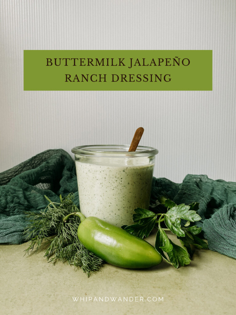 fresh jalapenos and herbs surrounding a glass jar of Buttermilk Jalapeno Ranch Dressing