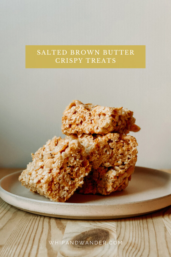 Salted Brown Butter Crispy Treats stacked on a dish resting on a wooden surface