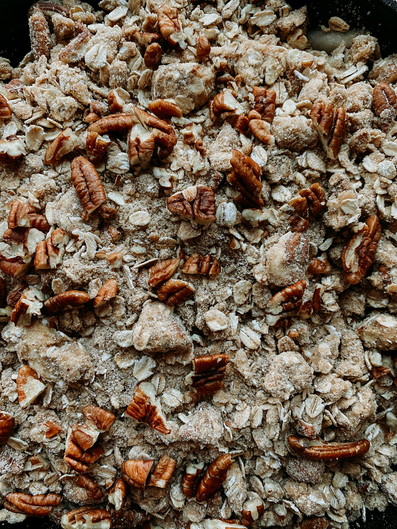 a closeup of a crisp topping with spices and pecans mixed in prior to baking