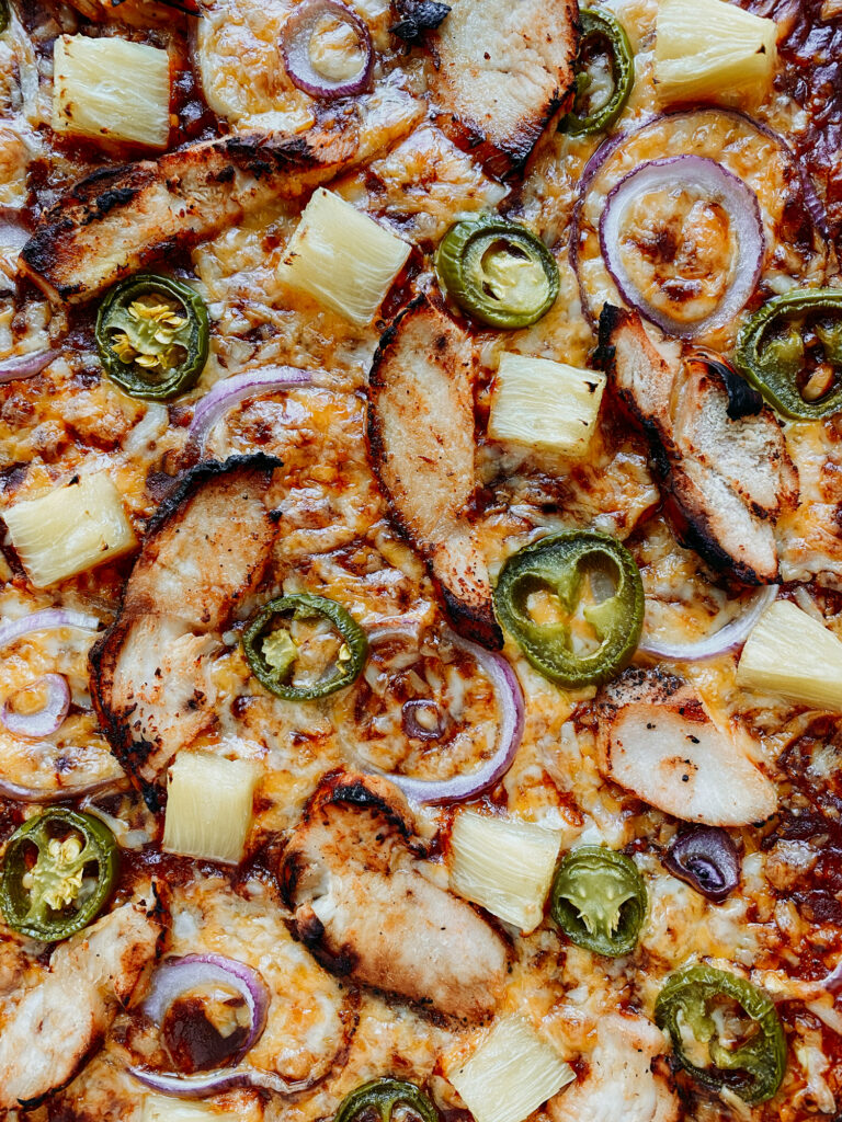Closeup of ingredients on a freshly baked BBQ Chicken Pizza