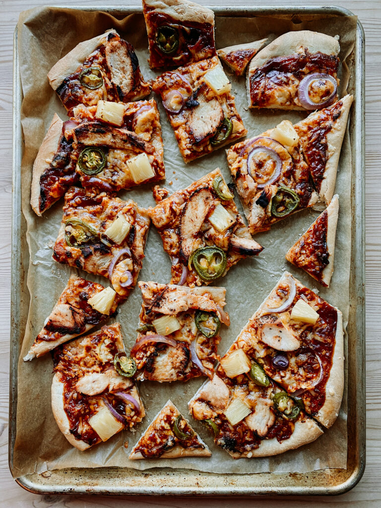 slices of BBQ Chicken Pizza on a baking sheet