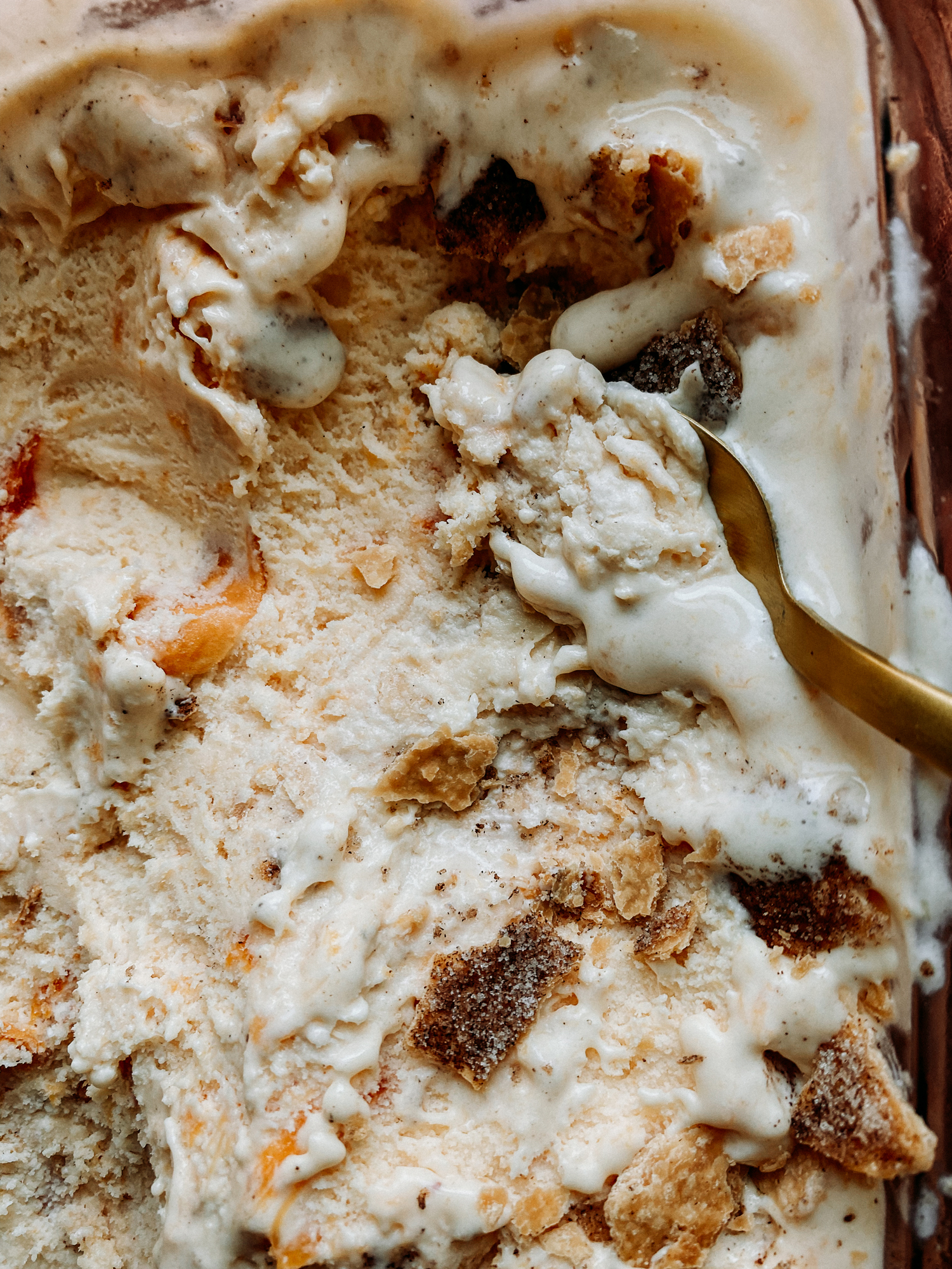 a gold spoon scooping through Buttermilk Peach Pie Ice Cream