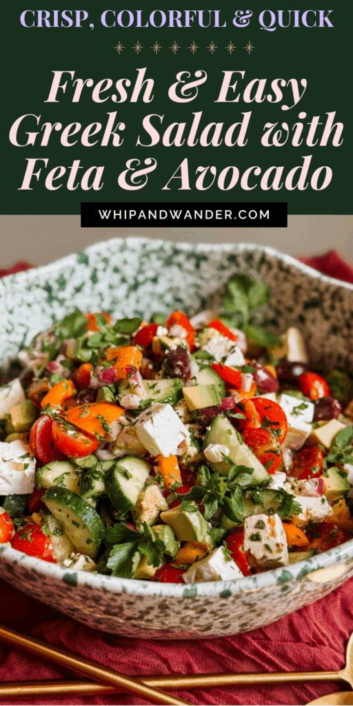 fresh greek salad with avocado, feta, cucumbers, tomatoes, peppers, and olives in a speckled serving bowl