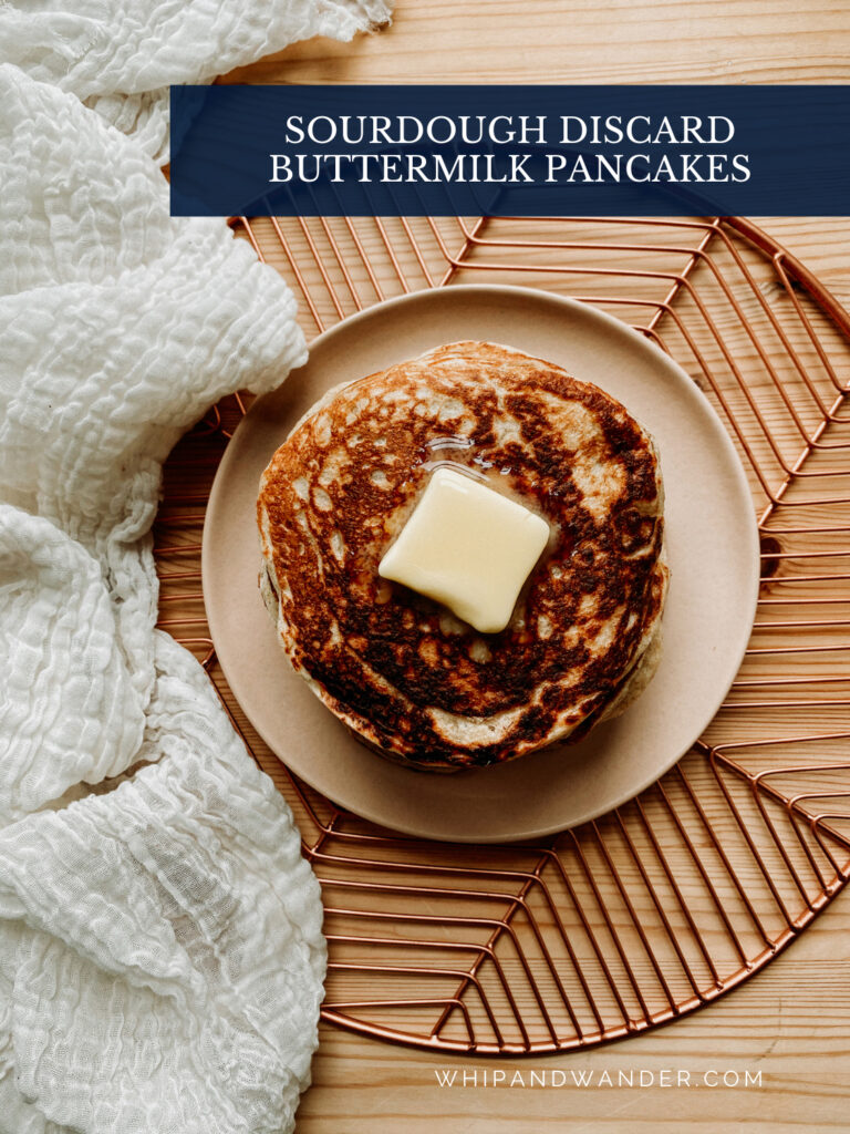 a top-down image of pancakes with melting butter on top