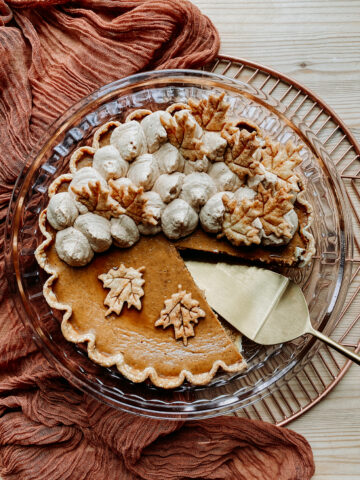a Maple Pumpkin Pie with a slice missing and a gold pie server in its place