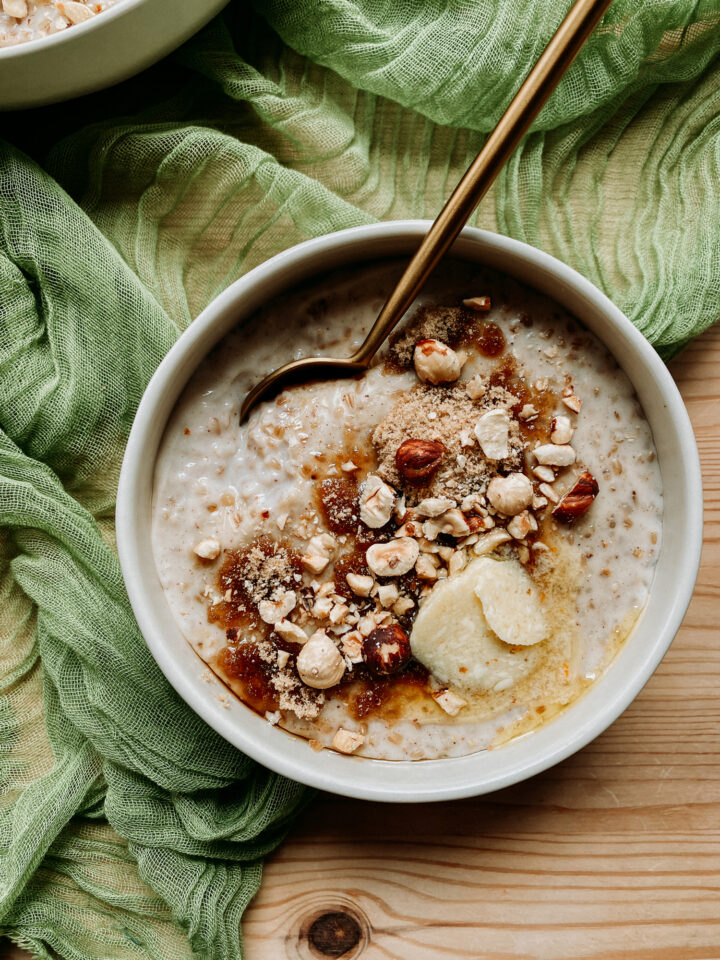 a bowl of Steel-Cut Oats with Whiskey Butter and a gold spoon