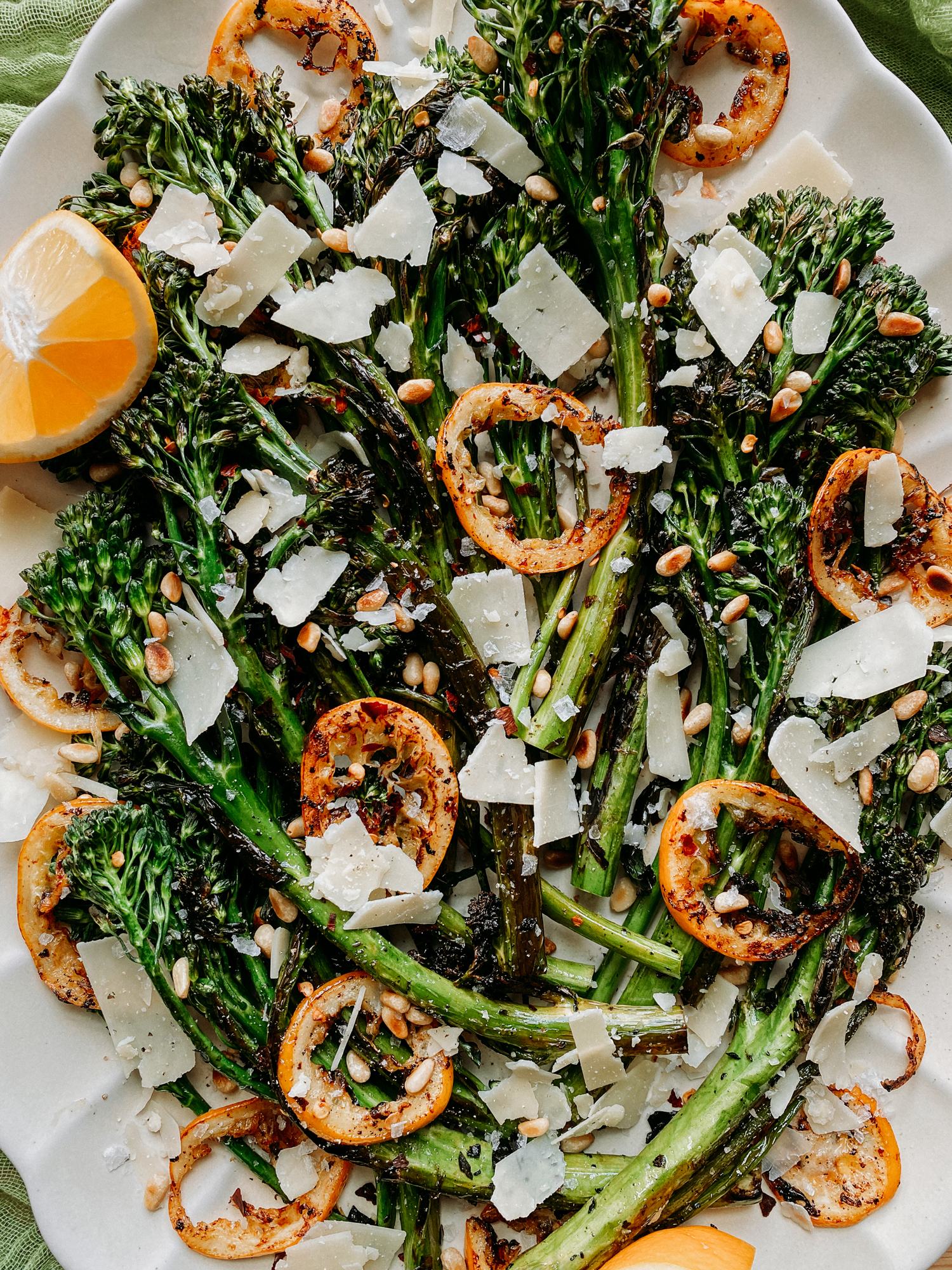charred broccolini stems mixed with butter browned lemon, nuts, and cheese