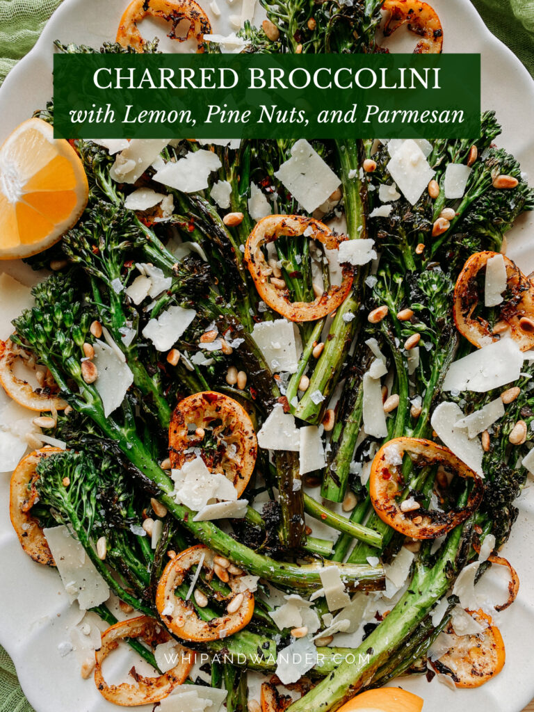 parmesan cheese shreds on top of charred broccolini with lemon slices