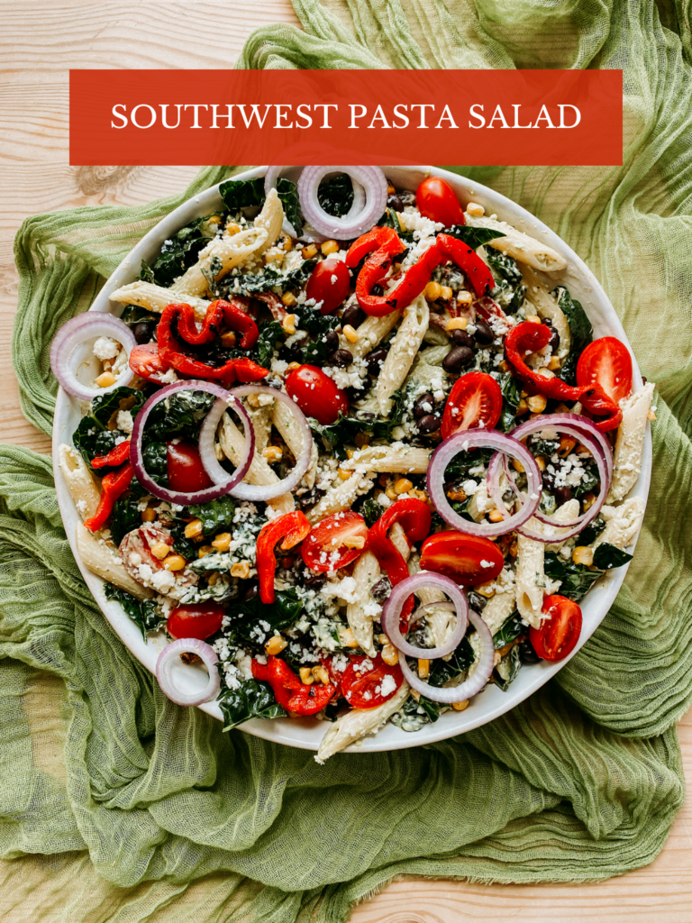 red onions, tomatoes, peppers, beans, corn, and kale in a penne pasta salad