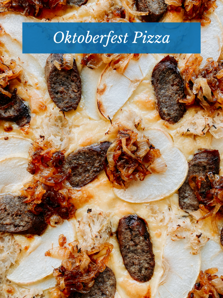 caramelized onions on top of a pizza with brat slices and apples