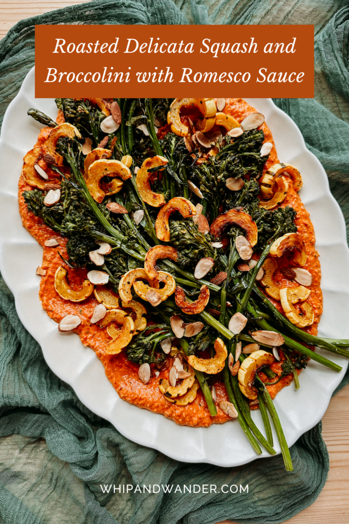 a large white platter covered in romesco sauce topped with roasted squash and broccolini