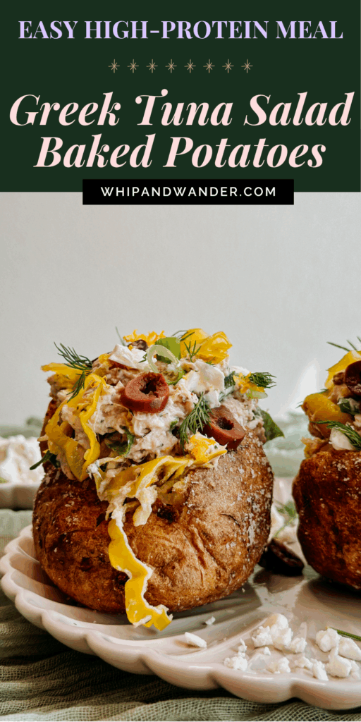 Close-up of a baked potato overflowing with Greek tuna salad, pepperoncini, olives, and dill, with a second potato in the background.