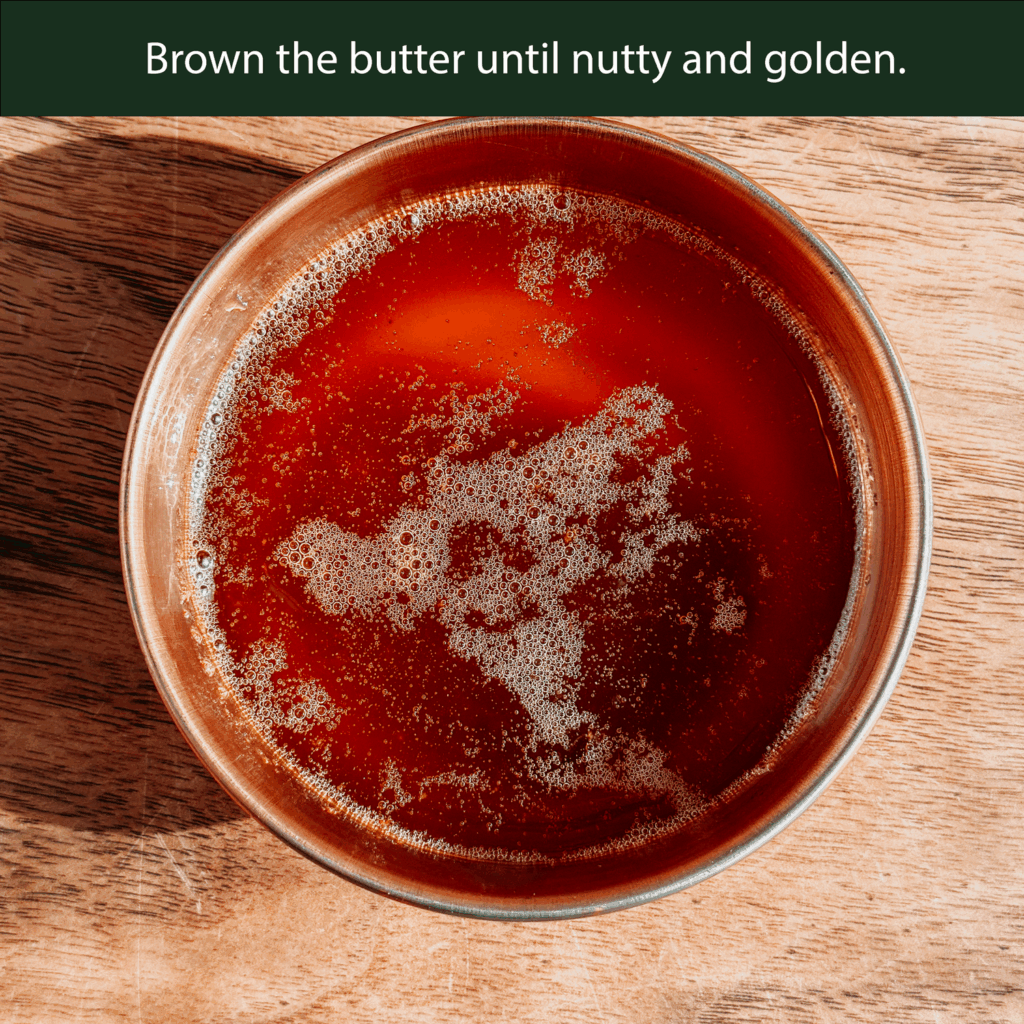 Browned butter in a saucepan with golden, nutty color for apple cider donut bread.